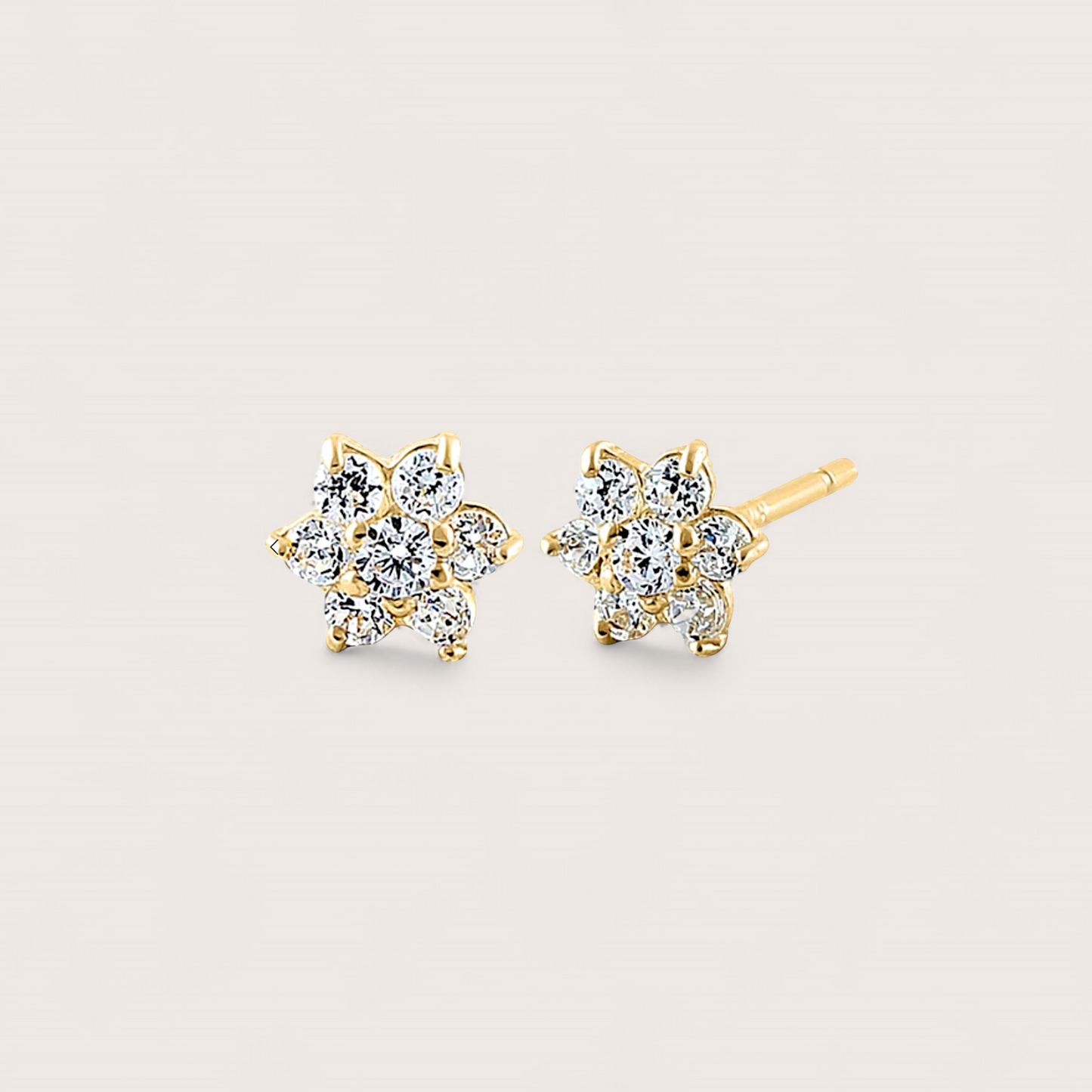 Close up of 14K yellow gold diamond earrings