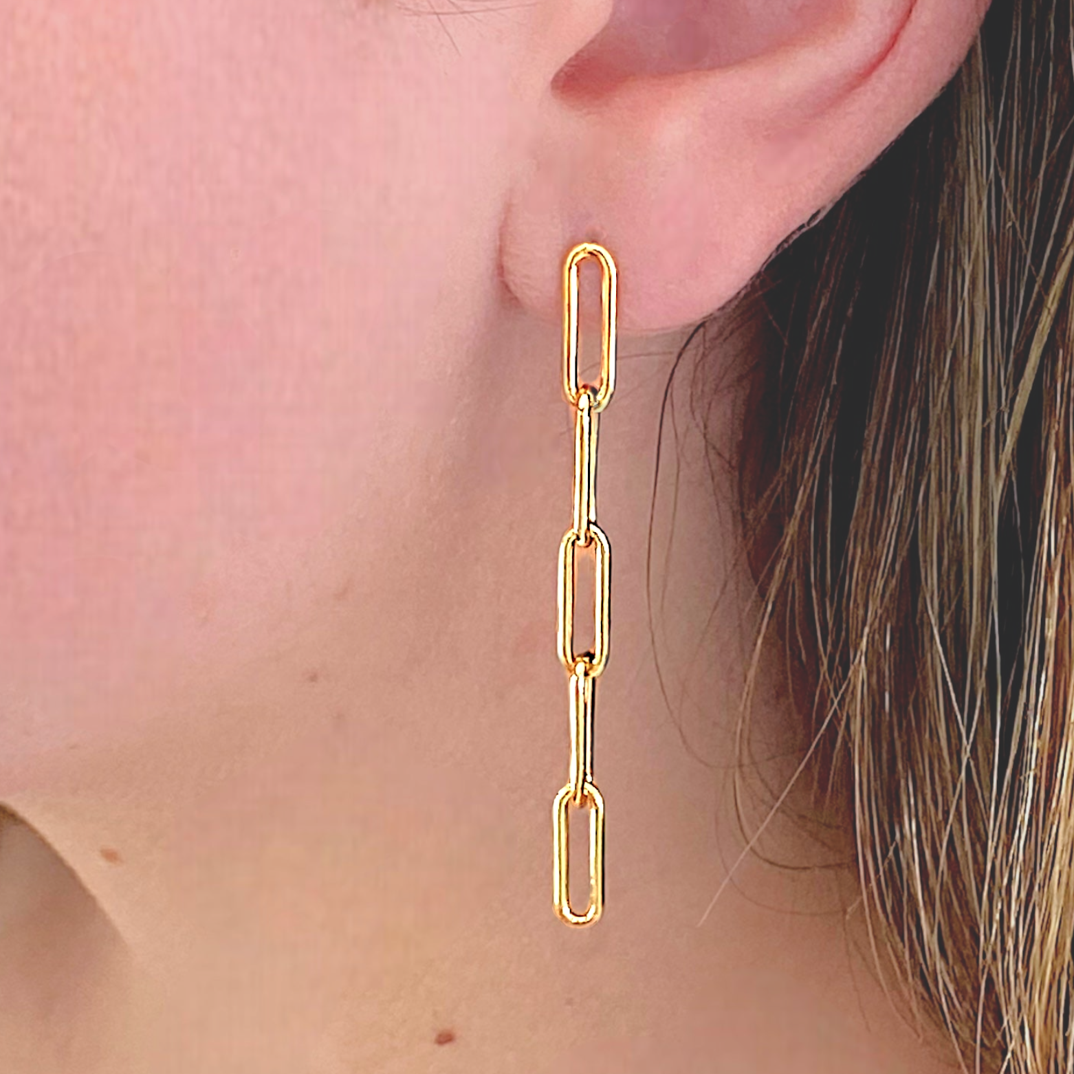 Model wearing the 5 Link Paperclip Chain Link Dangle Earrings 14k Gold Filled.
