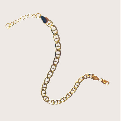 Detailed product shot of a 14k gold-filled flat mariner (anchor) link chain bracelet, featuring polished 5.0mm x 9.5mm links, displayed flat to show the extender chain and closure options. Available in 6.5" Fixed Length or 6.5" + 1" Extender, handmade by Ashley Nicole Jewelry.