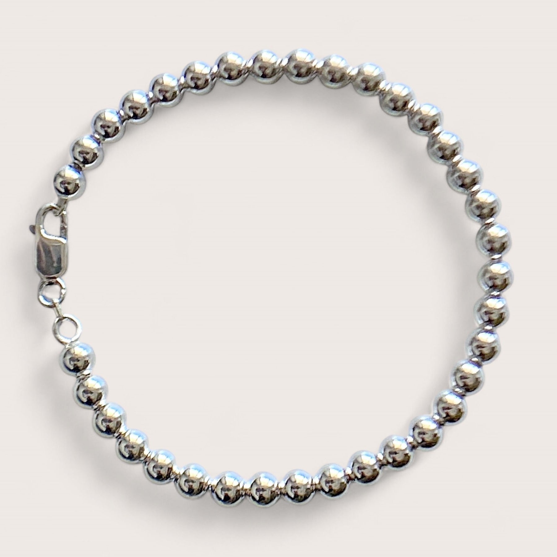Close up of 5mm Sterling Silver Beaded Ball Bracelet with shiny mirror finish and a large lobster clasp 