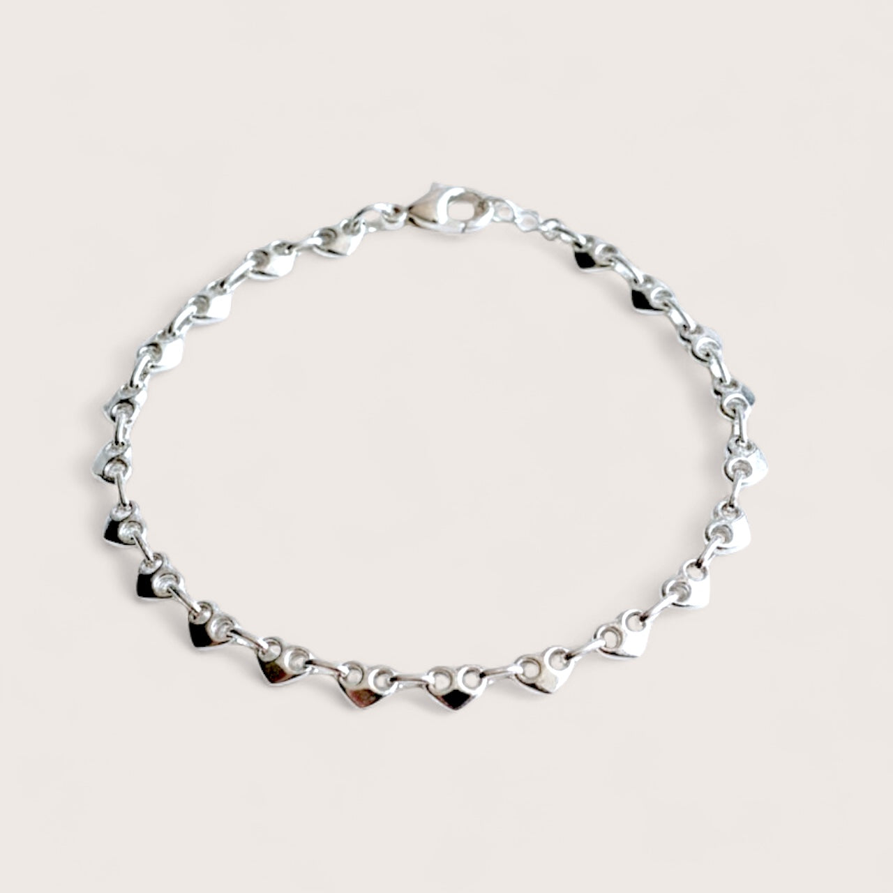 Dainty 4.5mm 925 solid sterling silver puffed mariner anchor chain bracelet displayed  showing puffy heart shaped links with a secure lobster clasp