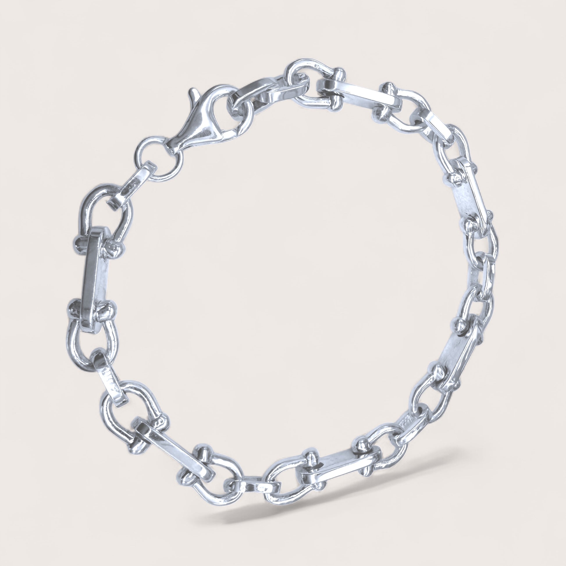 Silver chain bracelet on a light gray background