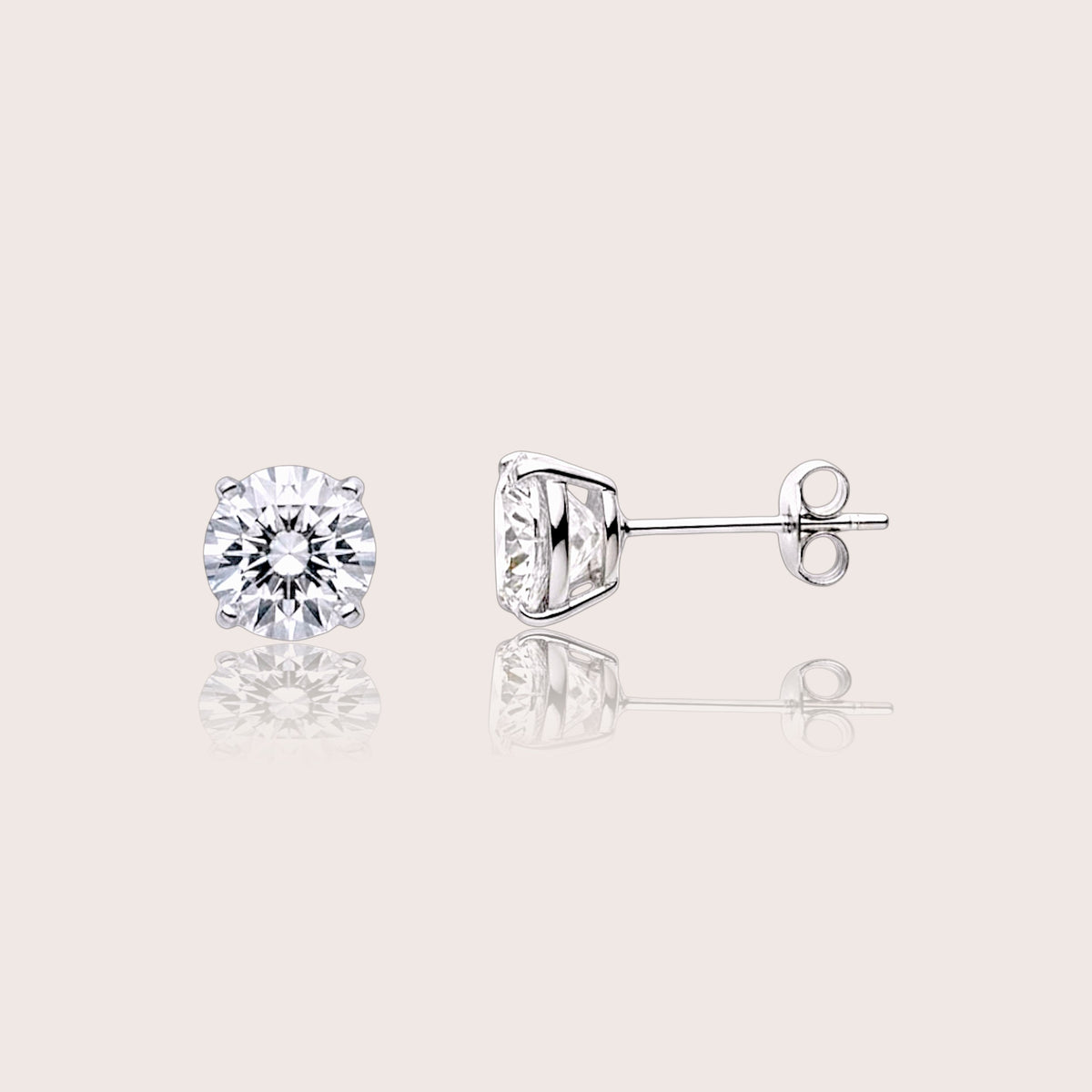 Front and side views of round moissanite stud earrings showing four-prong basket settings and butterfly pushbacks.