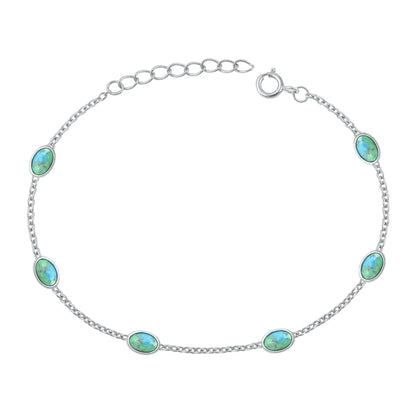 Silver bracelet with turquoise stones on a white background