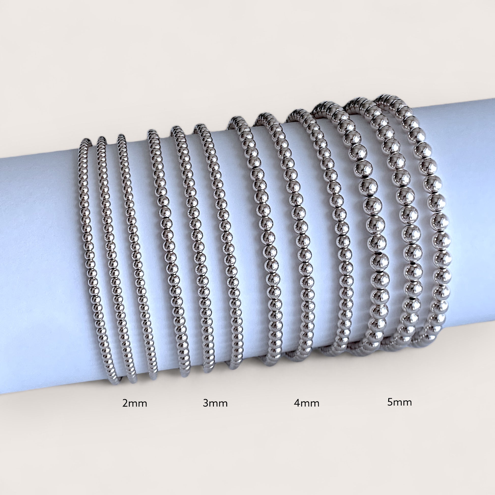 Close up image showing Sterling silver beaded bracelets, 2mm, 3mm 4mm, 5mm, side by side for comaprison  