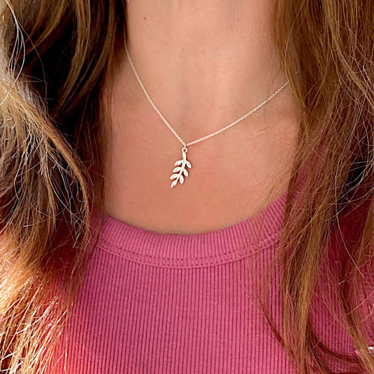 A model wearing a solid 925 sterling silver olive branch necklace