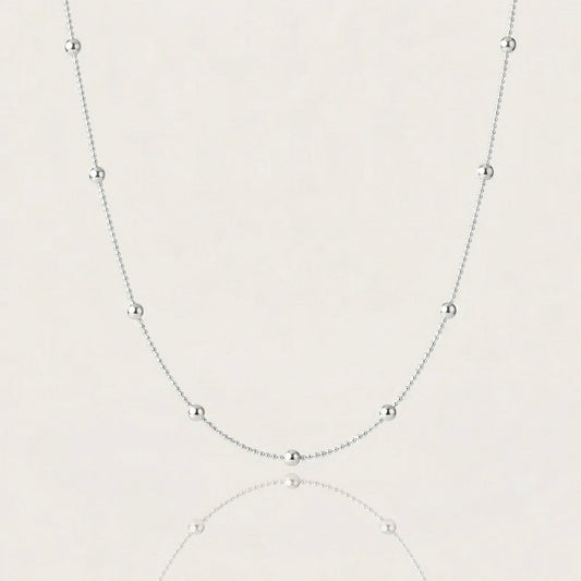 Close-up shot of 925 sterling silver satellite station necklace a plain background, showcasing the high-polish 3mm round beads on 1mm smooth ball chain.