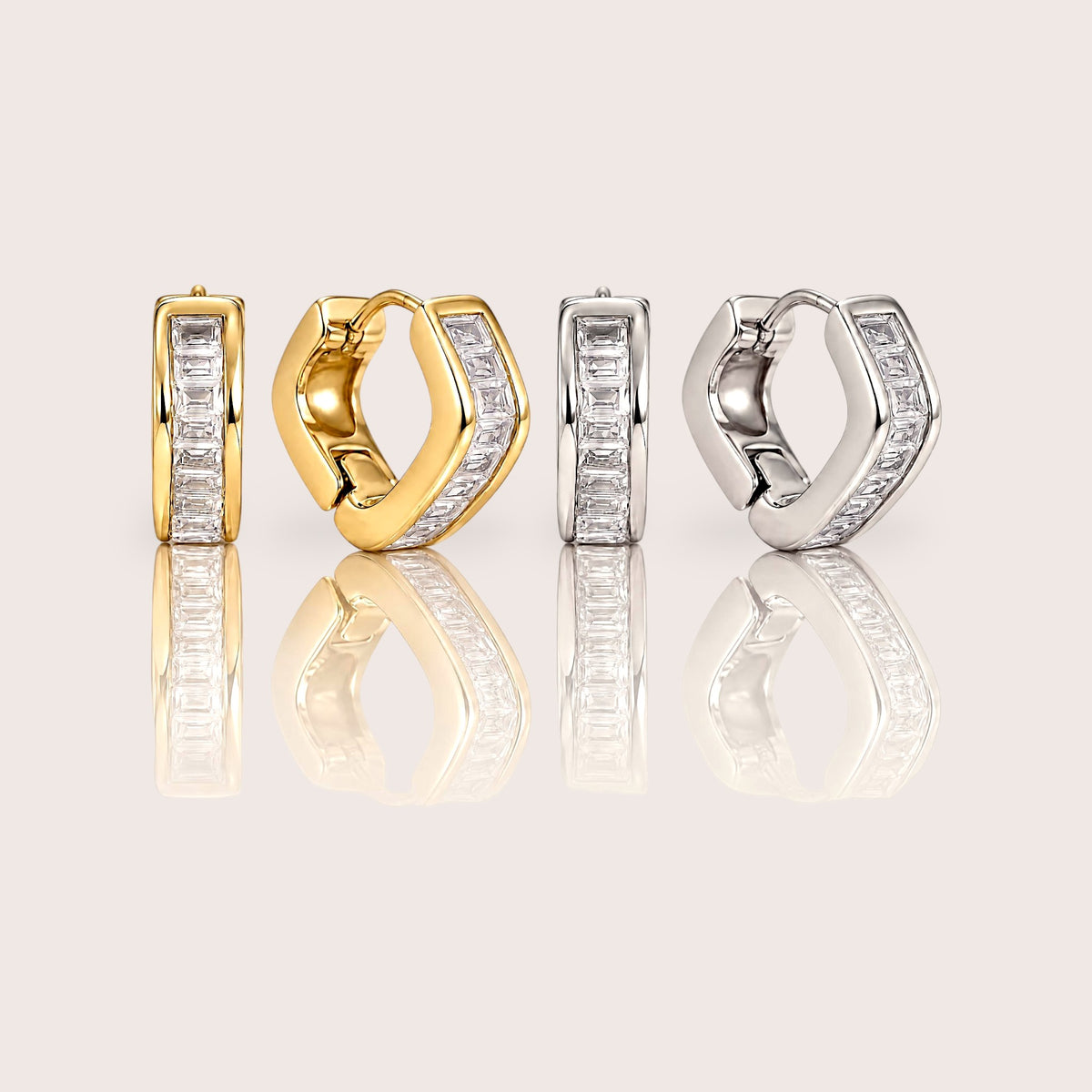 Gold and silver-tone hex huggie hoop pairs displayed side by side, showing baguette stone channels and angular profiles.