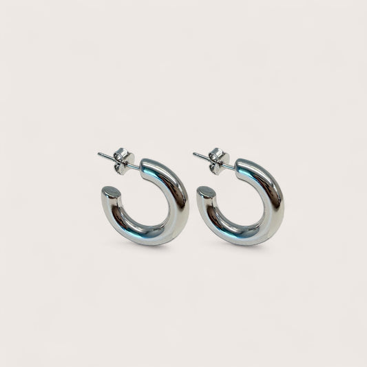 Silver hoop earrings on a light gray background