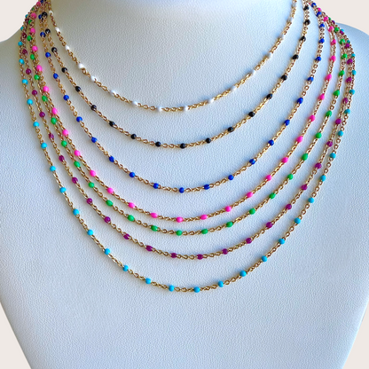 Gold filled dainty chain with colorful glossy enamel resin beadsTwo green beaded necklaces on a light gray background