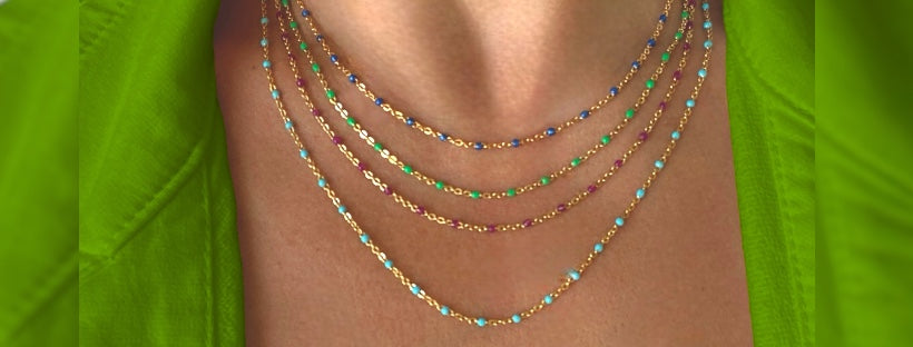 Stack of gold enamel bead necklace in multiple colors