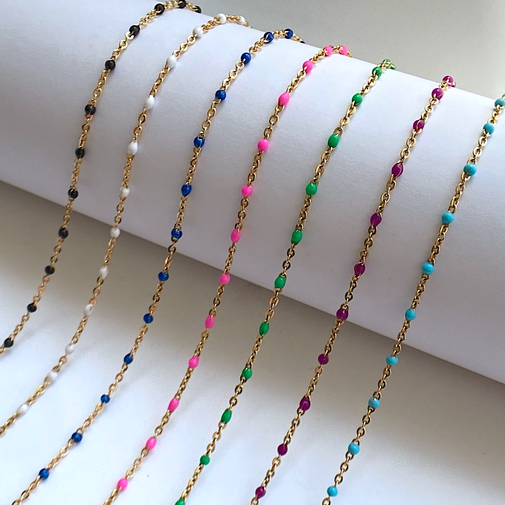Close-up of sparkling 14K Gold Chains with colorful beads stationed evenly, the satellite  beaded necklaces are waterproof and tarnish resistant made with no fade gold.
