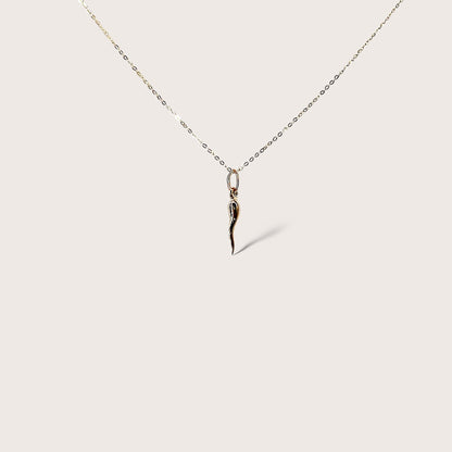 Showing a close up of the 14k Gold Necklace with the Small horn pendant 