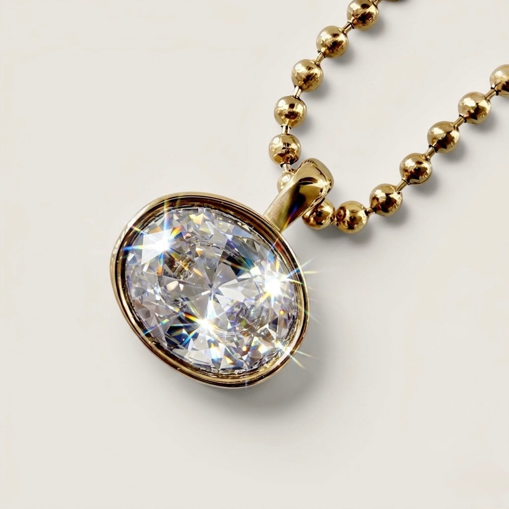 Close-up of the horizontal oval-cut cubic zirconia stone in a polished 18K gold bezel setting, showing light reflection on the beaded chain.