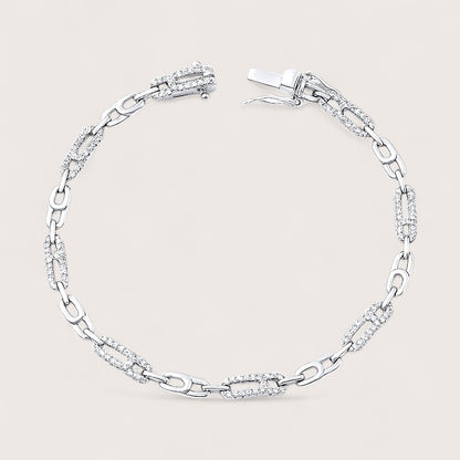 Silver bracelet with clear stones on a light gray background