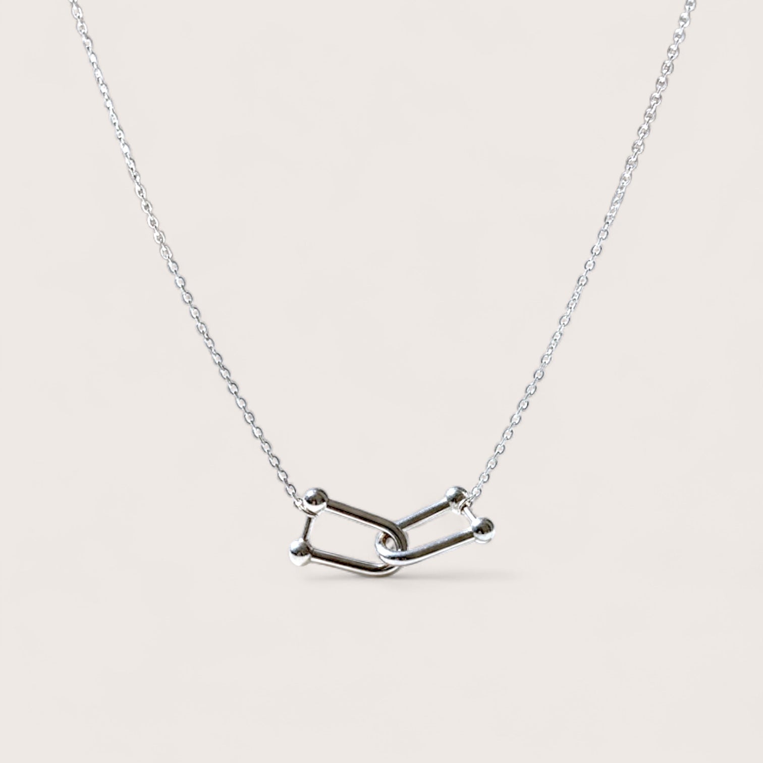 Silver necklace with a unique interlocking U link charms