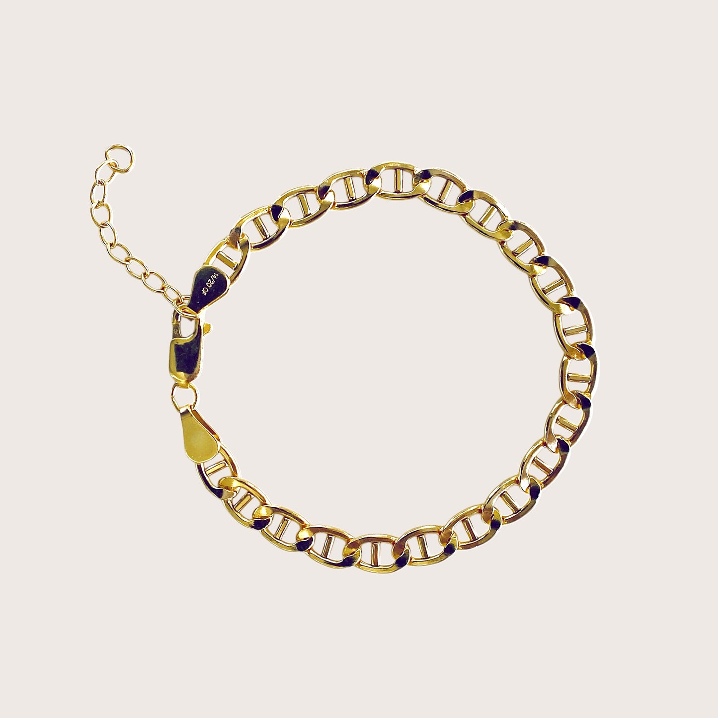 High polish 14k gold filled flat mariner anchor link chain bracelet lying flat on a minimalist surface by Ashley Nicole Jewelry⁠