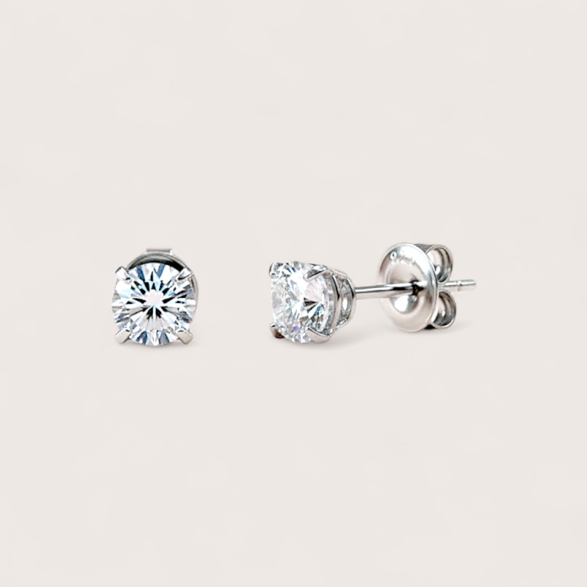Close up of GRA Certified Rhodium Sterling Silver Moissanite Earrings for Men or Women two size options: 

5mm (1.00CTW) – Each earring features a 0.50ct (DEW) moissanite, ideal for a timeless, understated sparkle.

6mm (1.60CTW) – Each earring features a 0.80ct (DEW) moissanite, offering a bolder, more luxurious presence.

