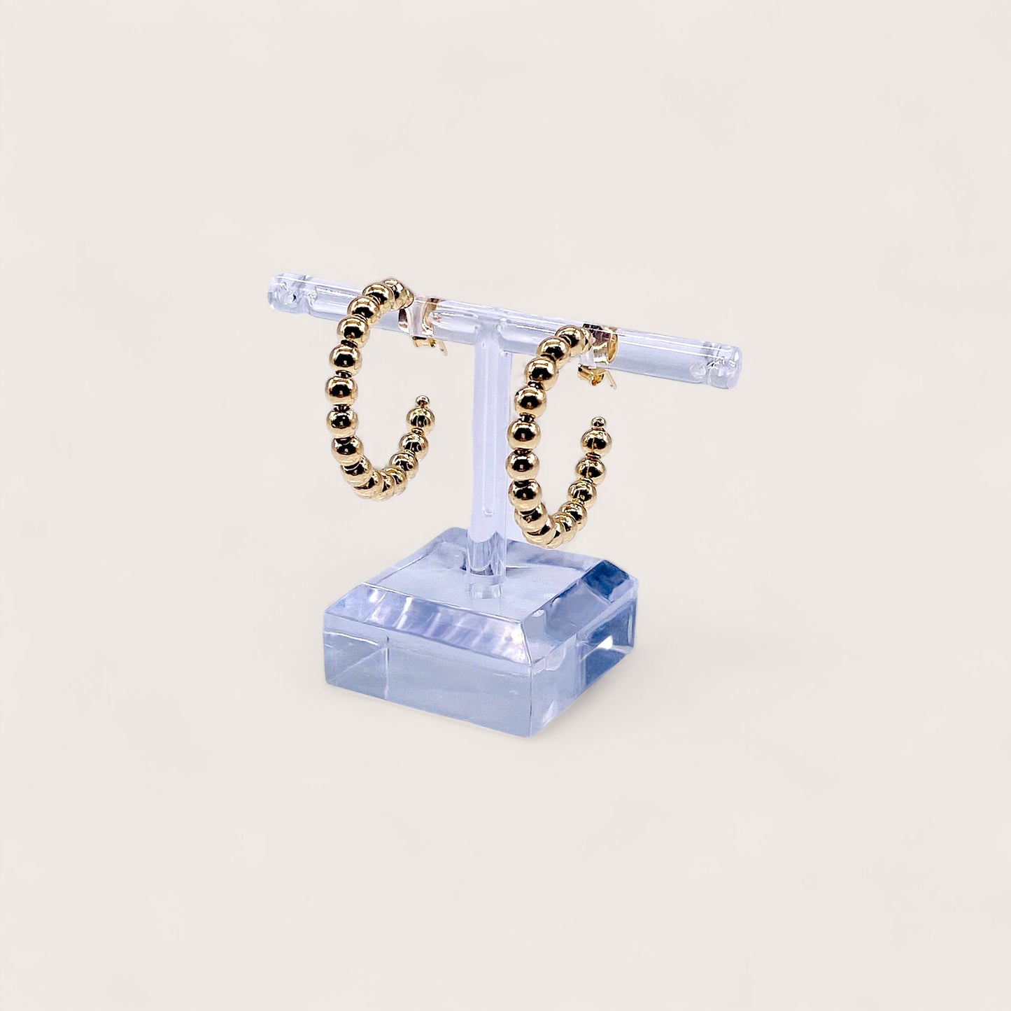 Close-up highlighting the uniform 4.2mm high-shine gold beads and the smooth, secure push-back post closure.