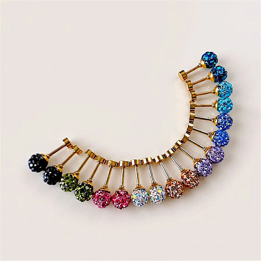 Crystal ball stud earrings in matching color pairs, showing sparkling round balls, gold posts, and screw-back closures on a neutral background.