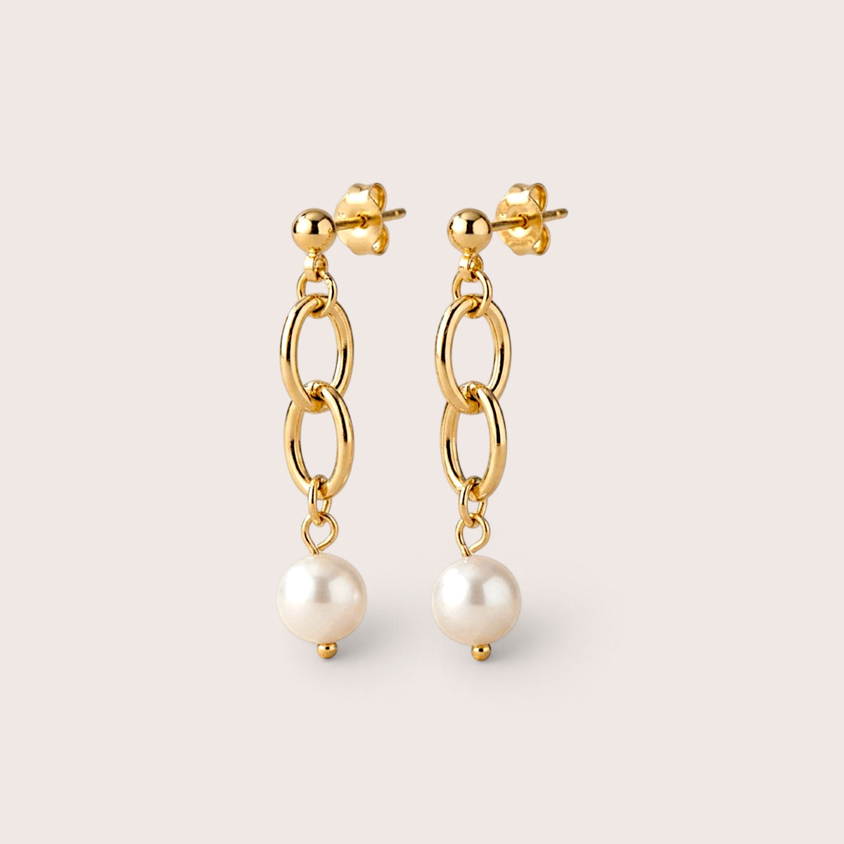Pair of gold ball-stud earrings with two interlocking oval links and white pearl drops, shown upright on a neutral background.