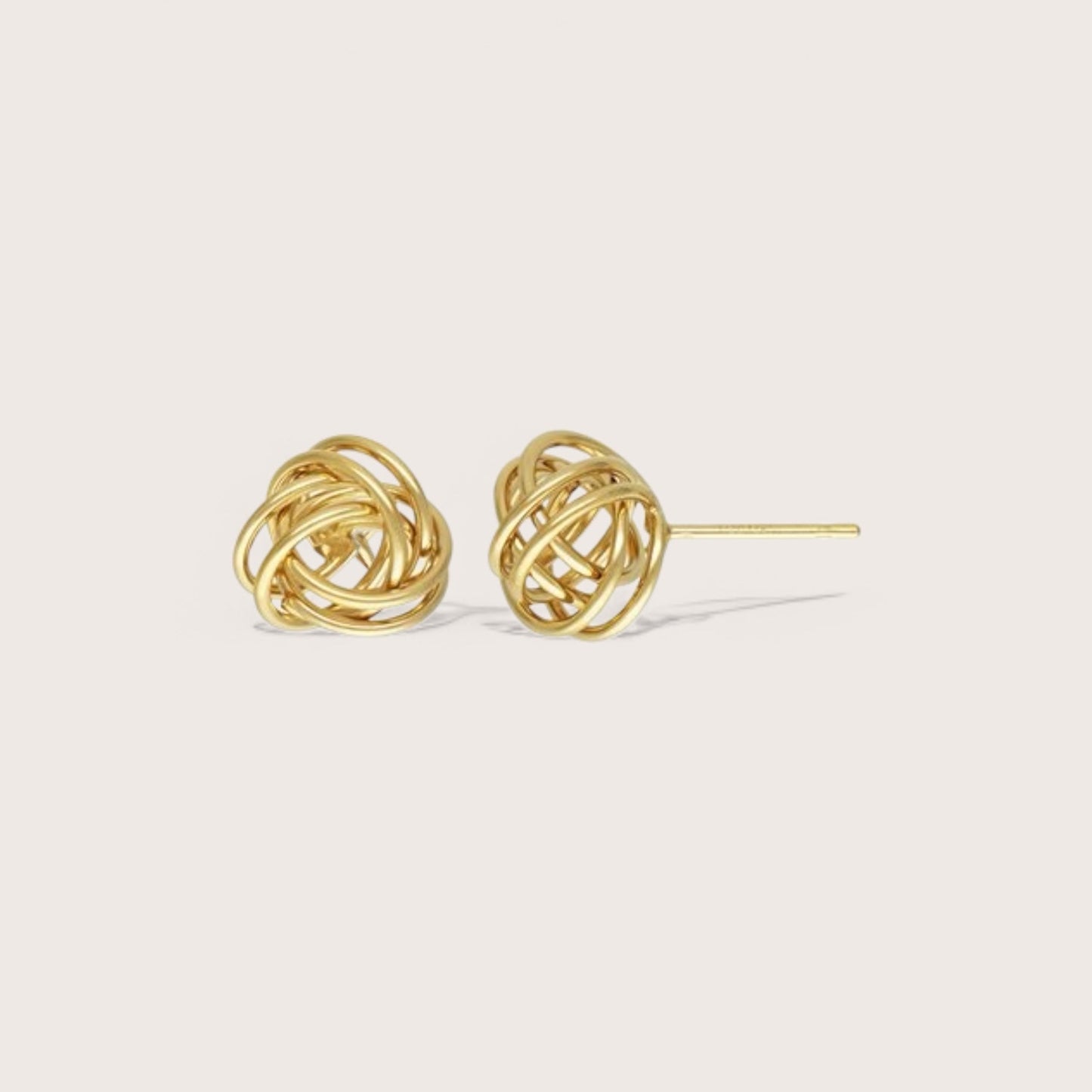 A pair of gold-filled open love knot stud earrings on a white background.