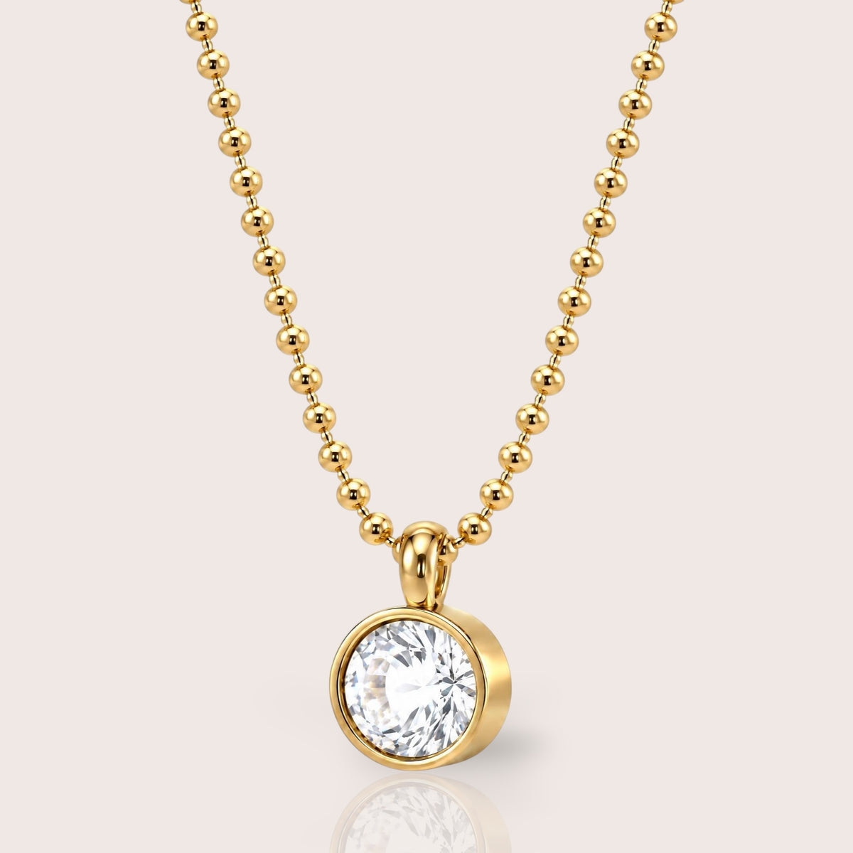 18K gold PVD stainless steel horizontal oval bezel-set cubic zirconia pendant necklace on a 2mm beaded ball chain by Ashley Nicole Jewelry, front view with reflection