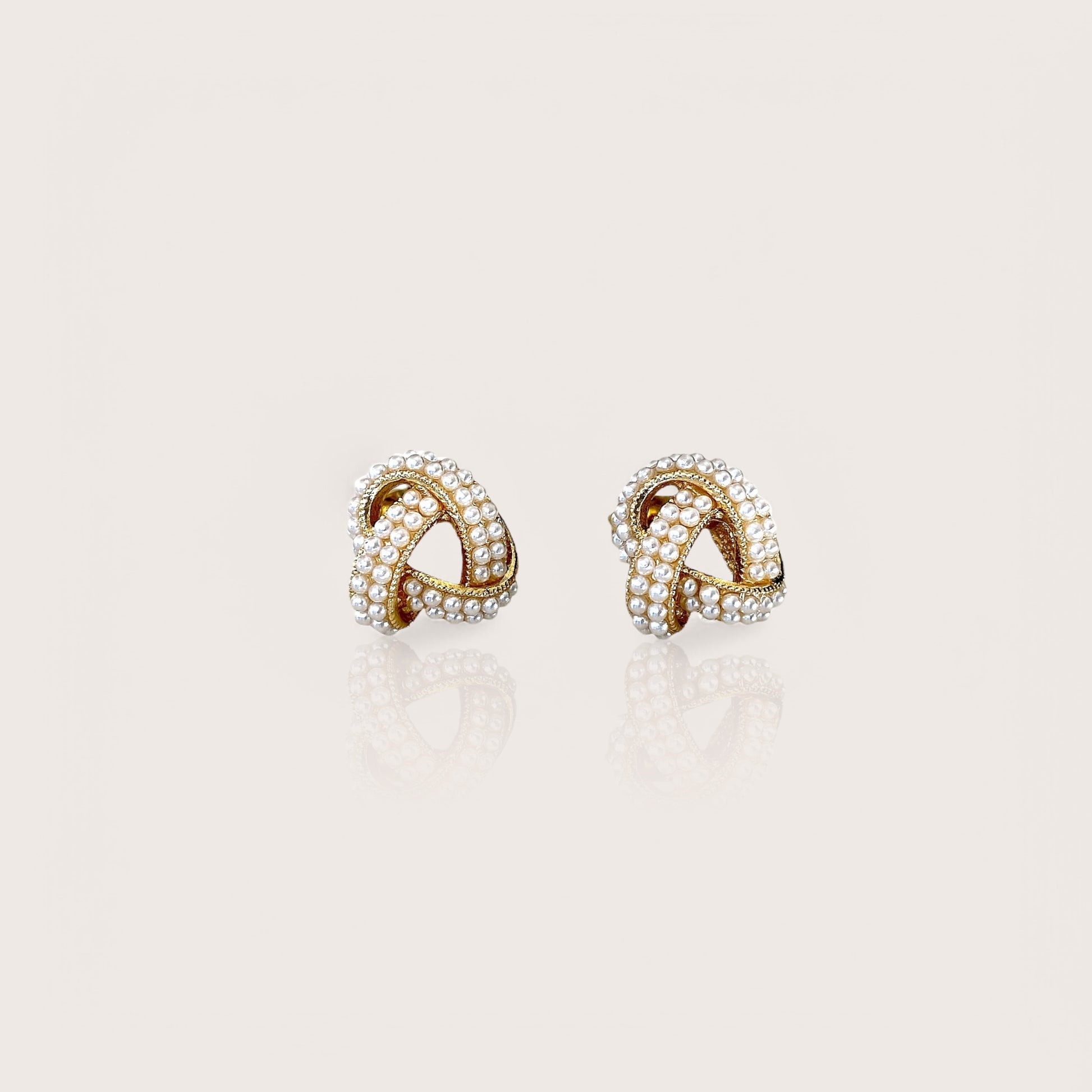 18K Gold Plated Pearl Cluster Love Knot Stud Earrings displaying the polished finish and beautiful ivory pearls.