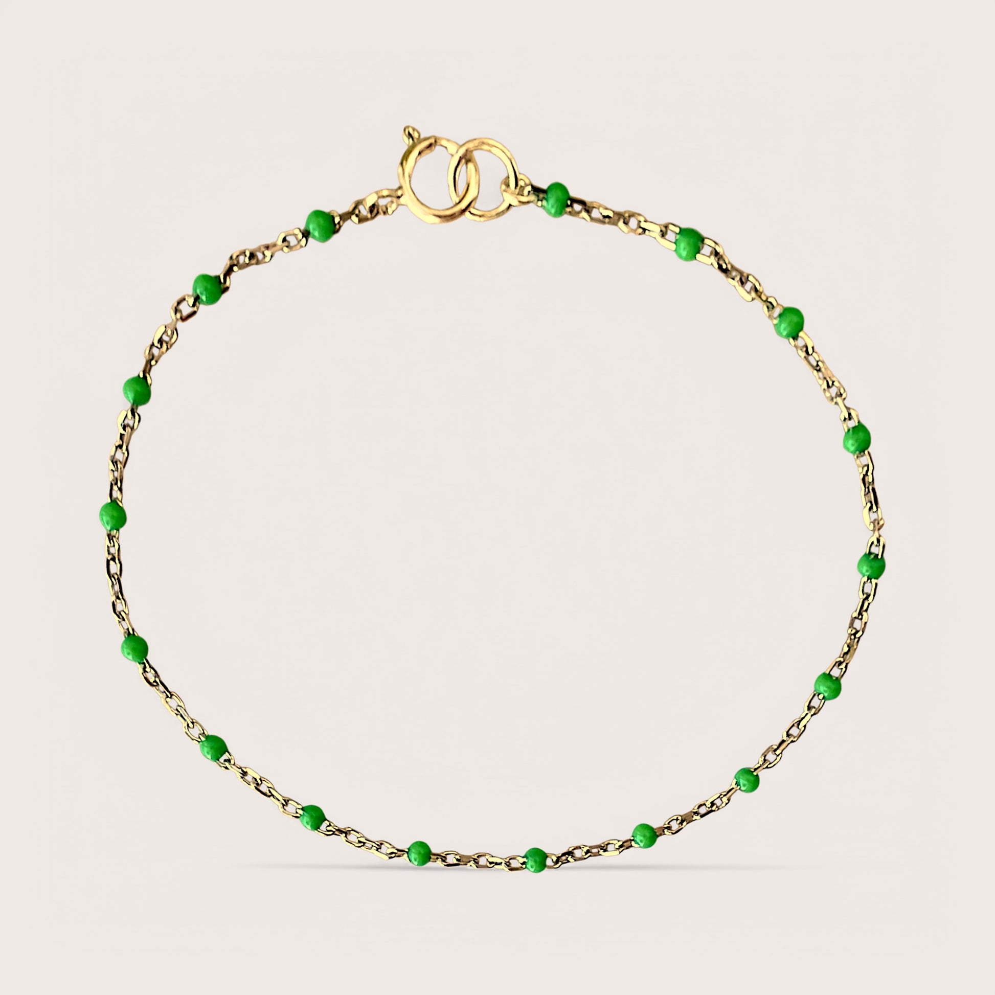 Elegant. Affordable. High-Quality. Introducing our Gold Enamel Bracelet, a stunning design. Crafted from 14K gold filled materials, this bracelet features emerald-colored enamel beads stationed along a delicate chain, offering a minimalist yet sophisticated look. See Size Chart for Help with Bracelet Sizing!&nbsp;