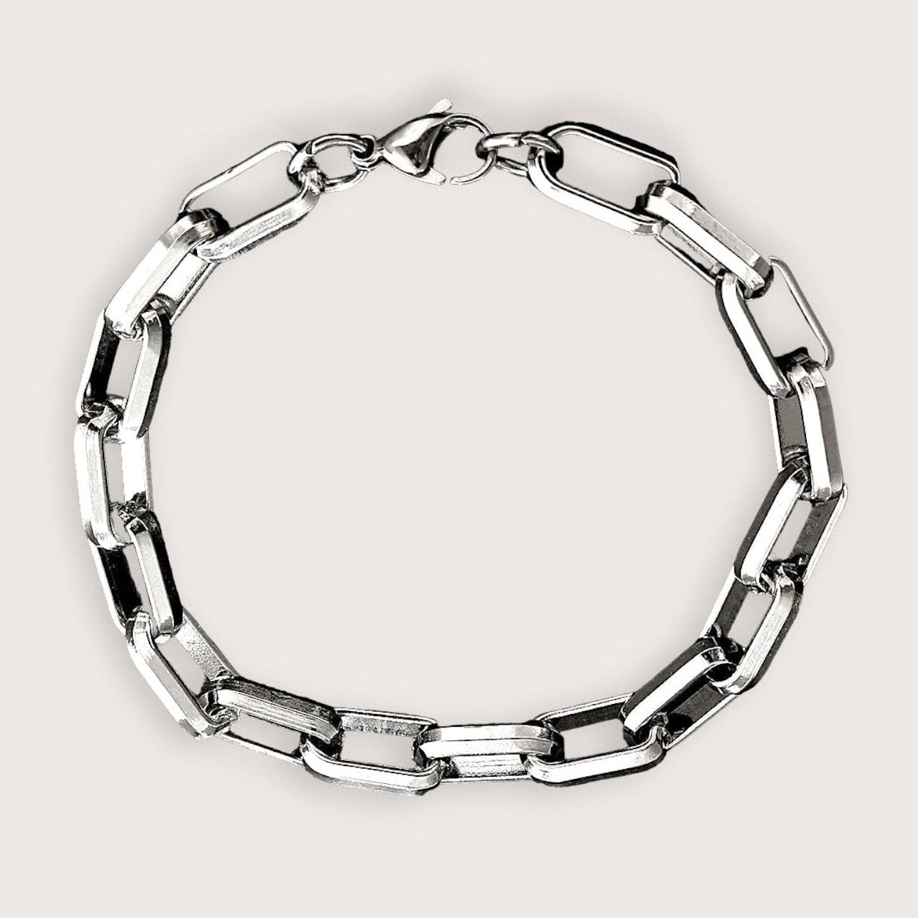 A stainless steel bracelet with a heavy robust and sophisticated design, featuring a series of interlinked elongated paperclip links solid metal rings.
