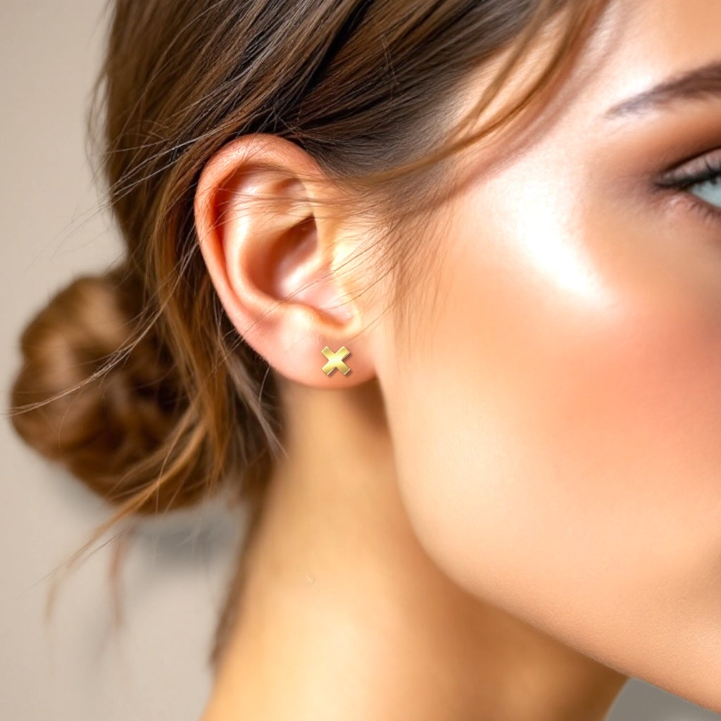 Minimalist X stud earrings styled on ear