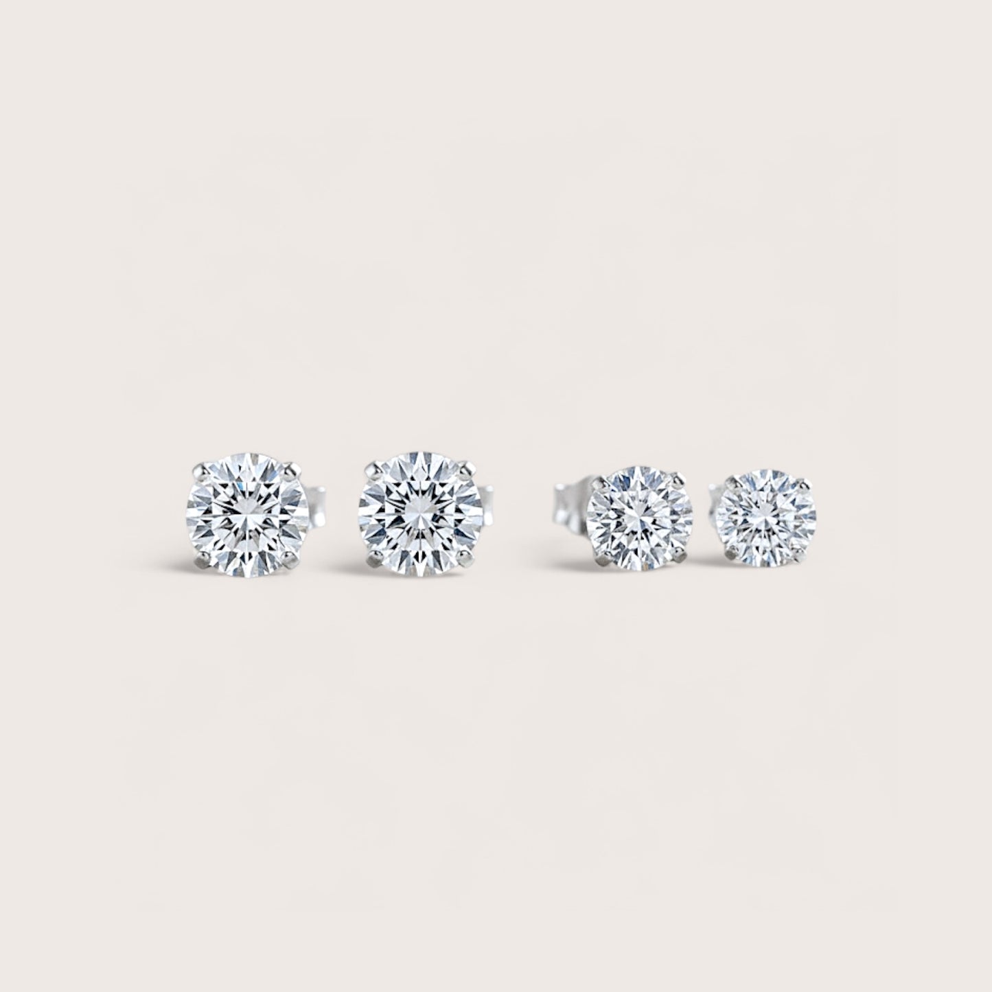 Close up image of Rhodium Sterling Silver Moissanite Earrings showing size options side by side - 5mm (1.00CTW) – 0.50ct (DEW)  &  6mm (1.60CTW) – 0.80ct (DEW) 