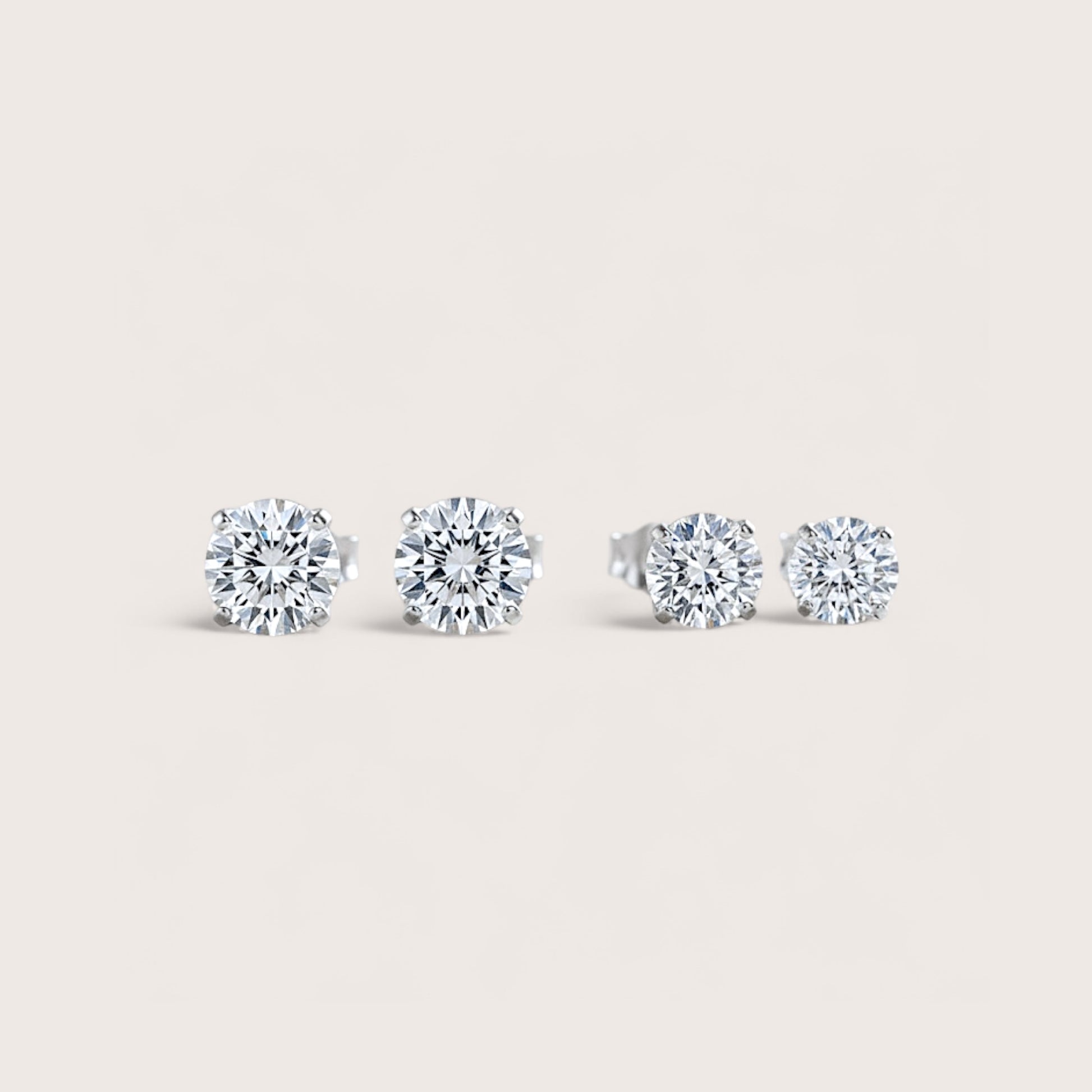 Close up image of Rhodium Sterling Silver Moissanite Earrings showing size options side by side - 5mm (1.00CTW) – 0.50ct (DEW)  &  6mm (1.60CTW) – 0.80ct (DEW) 