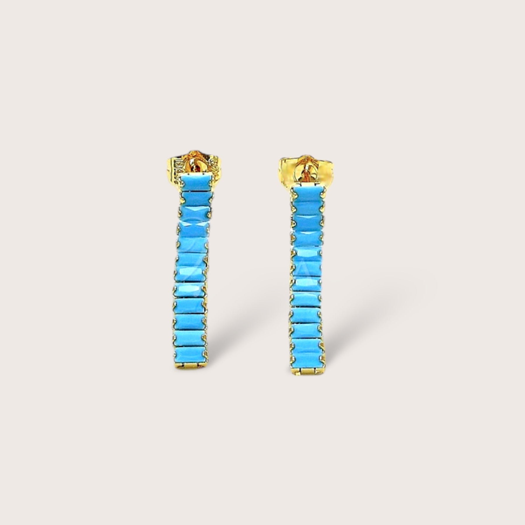 These Turquoise Baguette Earrings are the perfect addition to any outfit! The gold dangle earrings feature stunning Turquoise gemstones that add a bold and chic flair to your everyday look. A thoughtful and fun gift for anyone who loves fashion. Elevate your style and indulge in some elegant playfulness!
