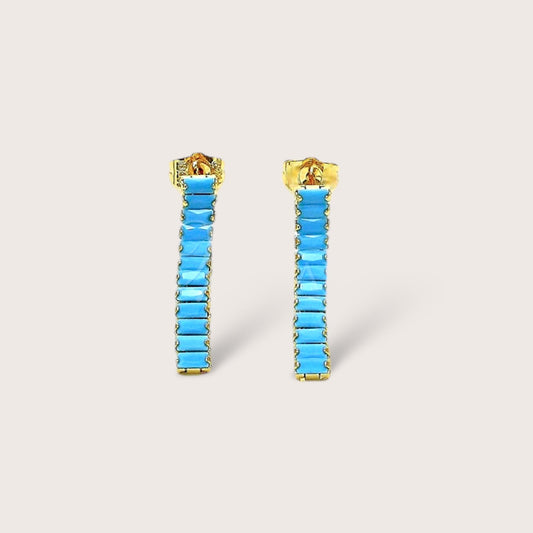 These Turquoise Baguette Earrings are the perfect addition to any outfit! The gold dangle earrings feature stunning Turquoise gemstones that add a bold and chic flair to your everyday look. A thoughtful and fun gift for anyone who loves fashion. Elevate your style and indulge in some elegant playfulness!