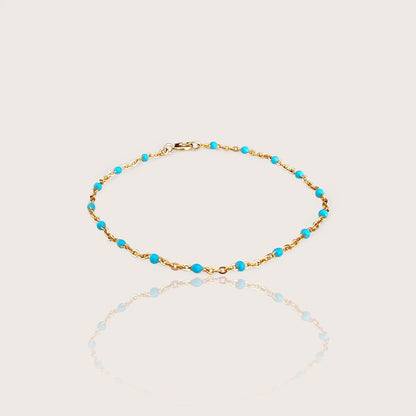 This high-quality Vibrant Turquoise Gold Chain Bracelet is made with 1.8mm delicate enamel beads and strong 14K gold fill. It's perfect for everyday wear, and can even be worn in the shower without losing its shine or color. This one-of-a-kind bracelet is handmade in sunny Laguna Beach, CA and comes in customizable sizes for everyone from newborns to adults. It's a fun and functional gift suitable for any occasion!