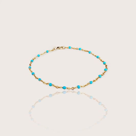 This high-quality Vibrant Turquoise Gold Chain Bracelet is made with 1.8mm delicate enamel beads and strong 14K gold fill. It's perfect for everyday wear, and can even be worn in the shower without losing its shine or color. This one-of-a-kind bracelet is handmade in sunny Laguna Beach, CA and comes in customizable sizes for everyone from newborns to adults. It's a fun and functional gift suitable for any occasion!