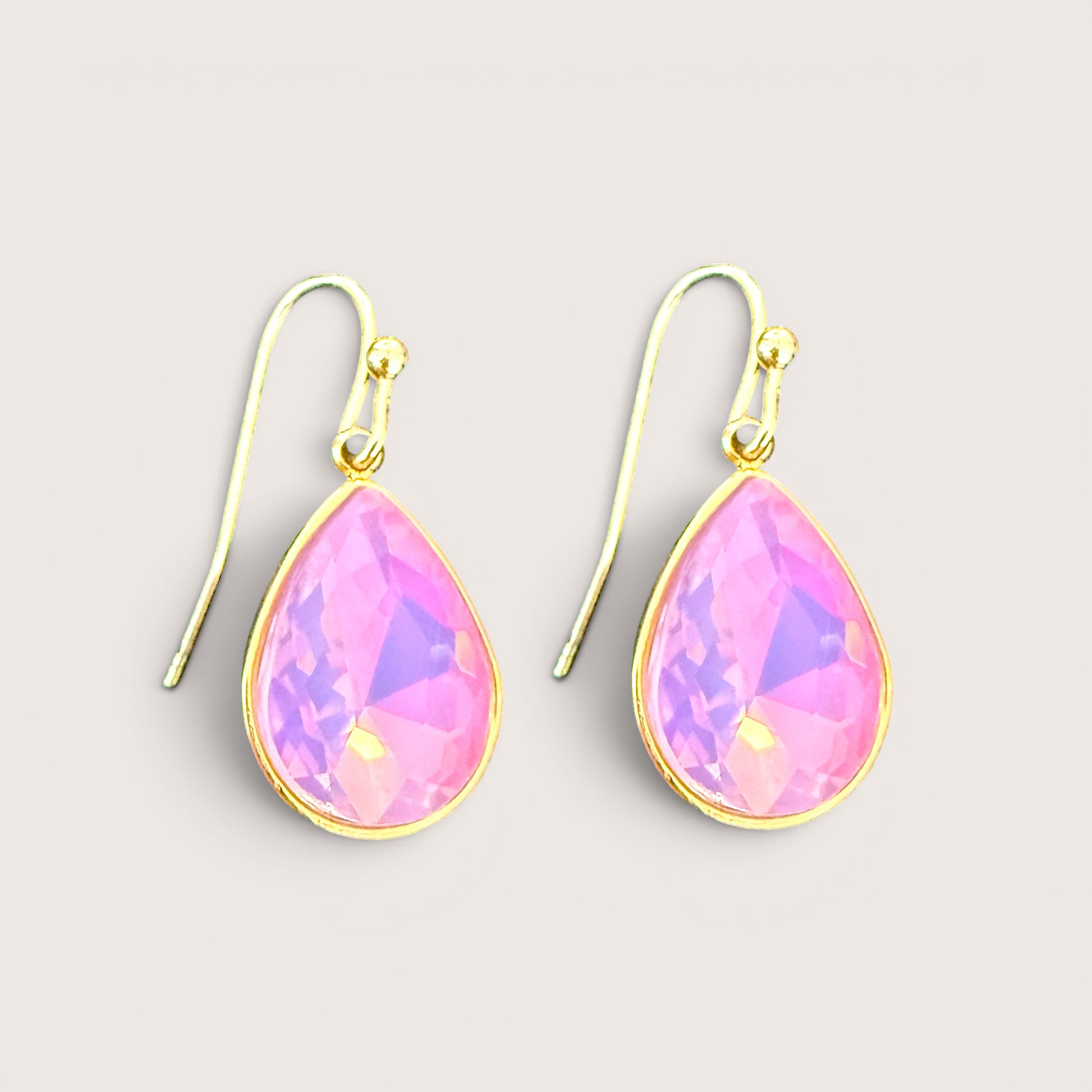 A pair of gold filled teardrop dangle earrings with faceted pink iridescent gemstones by ashley nicole jewelry 