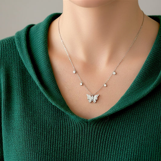 A model wearing an adjustable 16-inch 3D silver butterfly pendant necklace showing off its dimensional sparkle and brilliant dangling bezels.