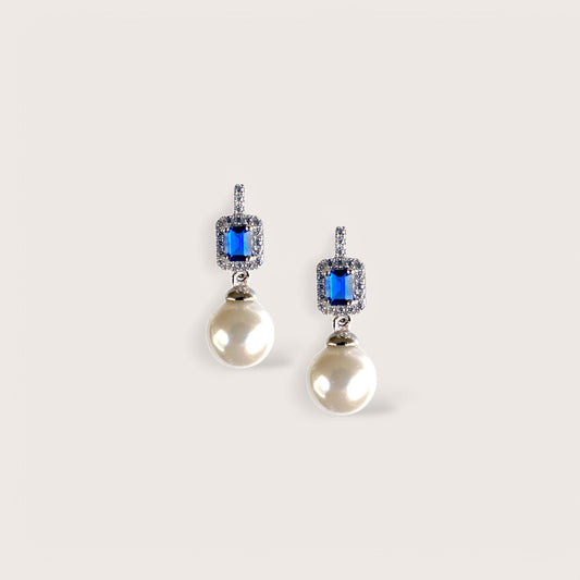 A pair of sterling silver drop earrings featuring blue gemstones and pearls