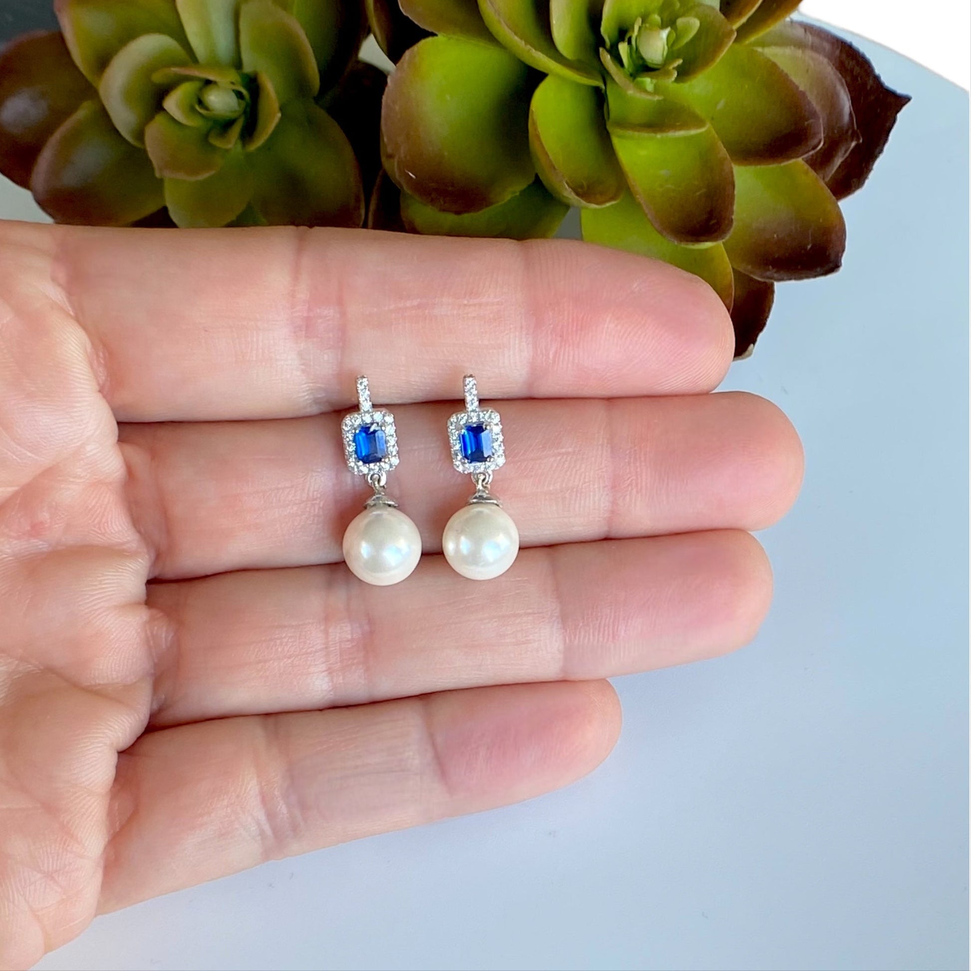 Sterling Silver Sapphire Pearl Drop Stud Earrings Shown in Hand for size visual