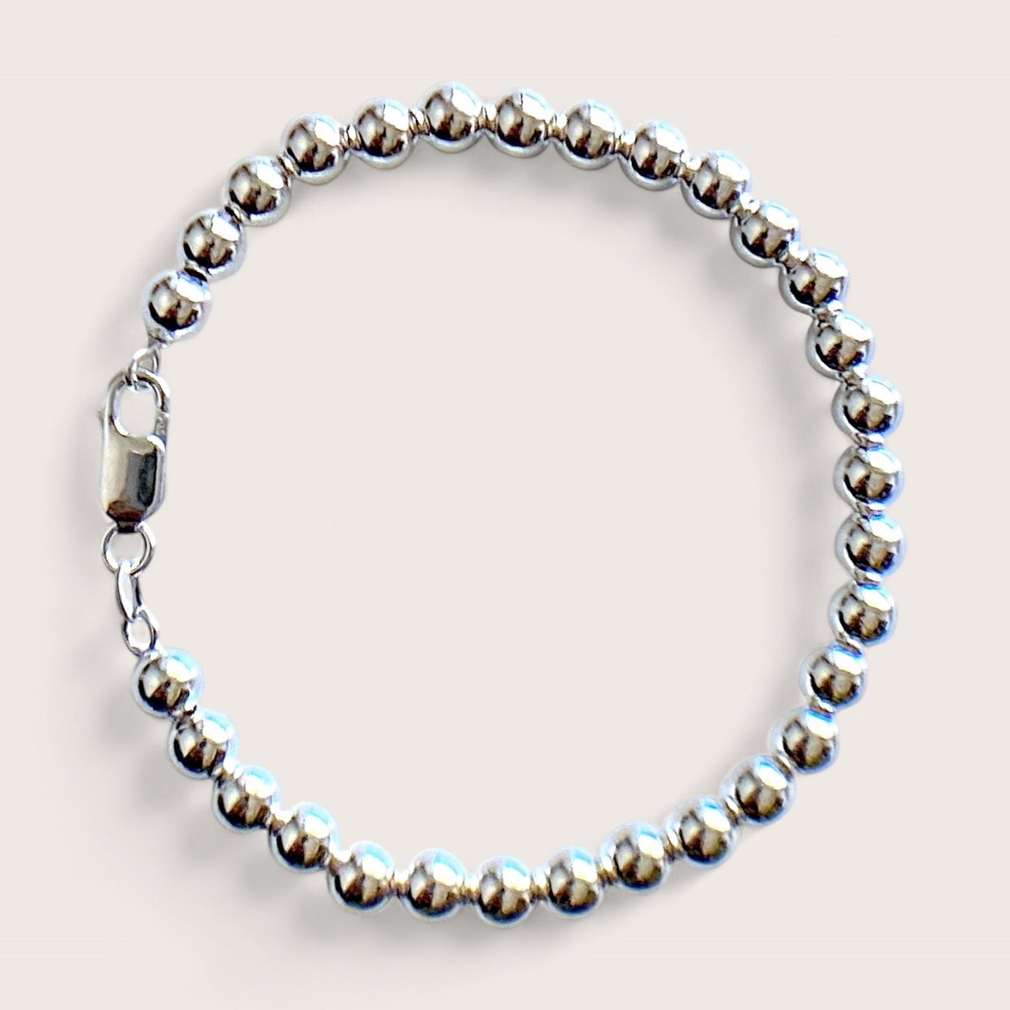 Close up of 6mm Sterling Silver Beaded Ball Bracelet with shiny mirror finish and a large lobster clasp 