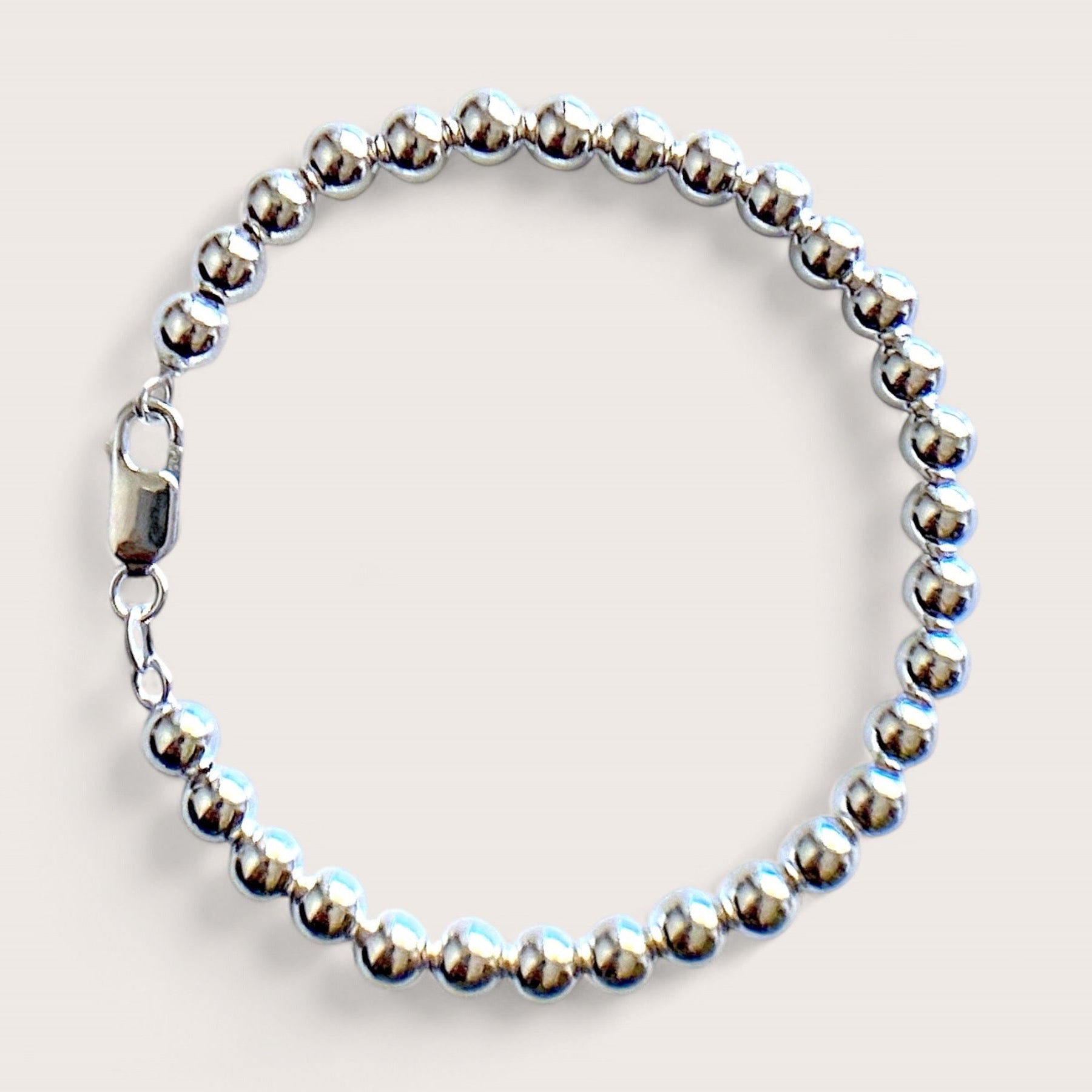 Close up of 6mm Sterling Silver Beaded Ball Bracelet with shiny mirror finish and a large lobster clasp 
