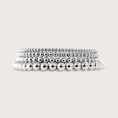 Close-up stack of 925 sterling silver beaded stretch bracelets showing 2mm, 3mm, 4mm, and 5mm widths
