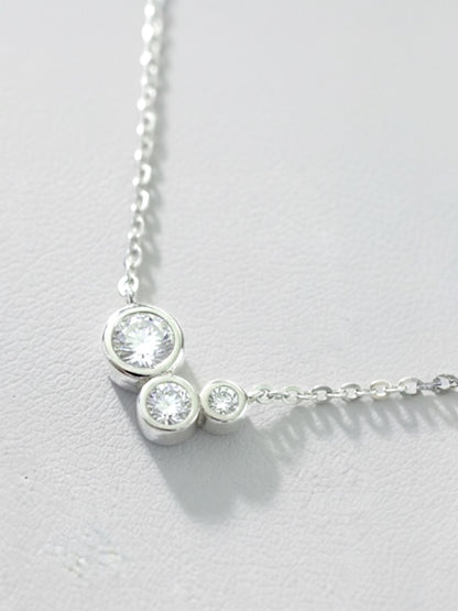 Close-up of bezel-set round moissanite cluster pendant