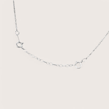 Close-up detail of dainty silver cable chain links and secure attachments with a bright mirror silver finish. Displays how to attach to necklace to make it longer.