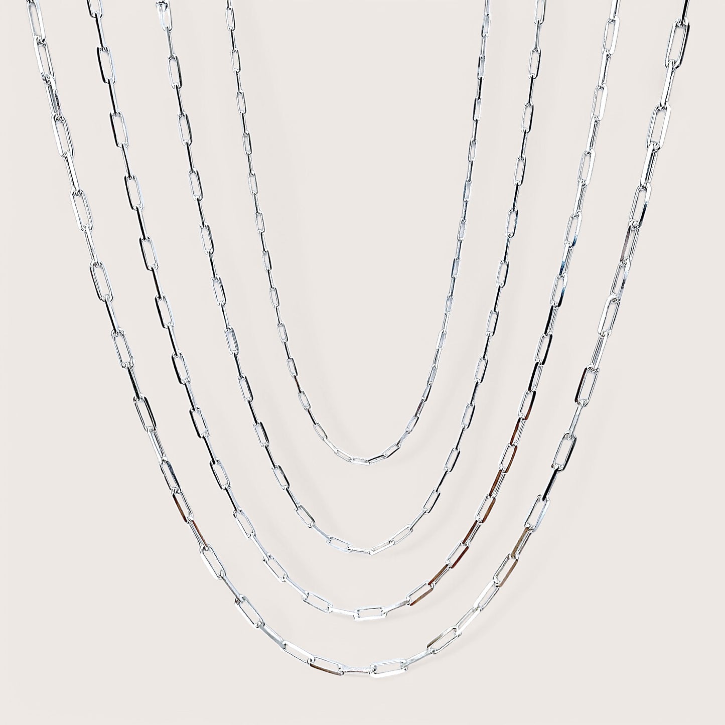 Side by Side of Solid 925 Italain Sterling Silver Paperclip Chain Necklaces for Men & Women. Chains are layered  showing virus width and length options. 