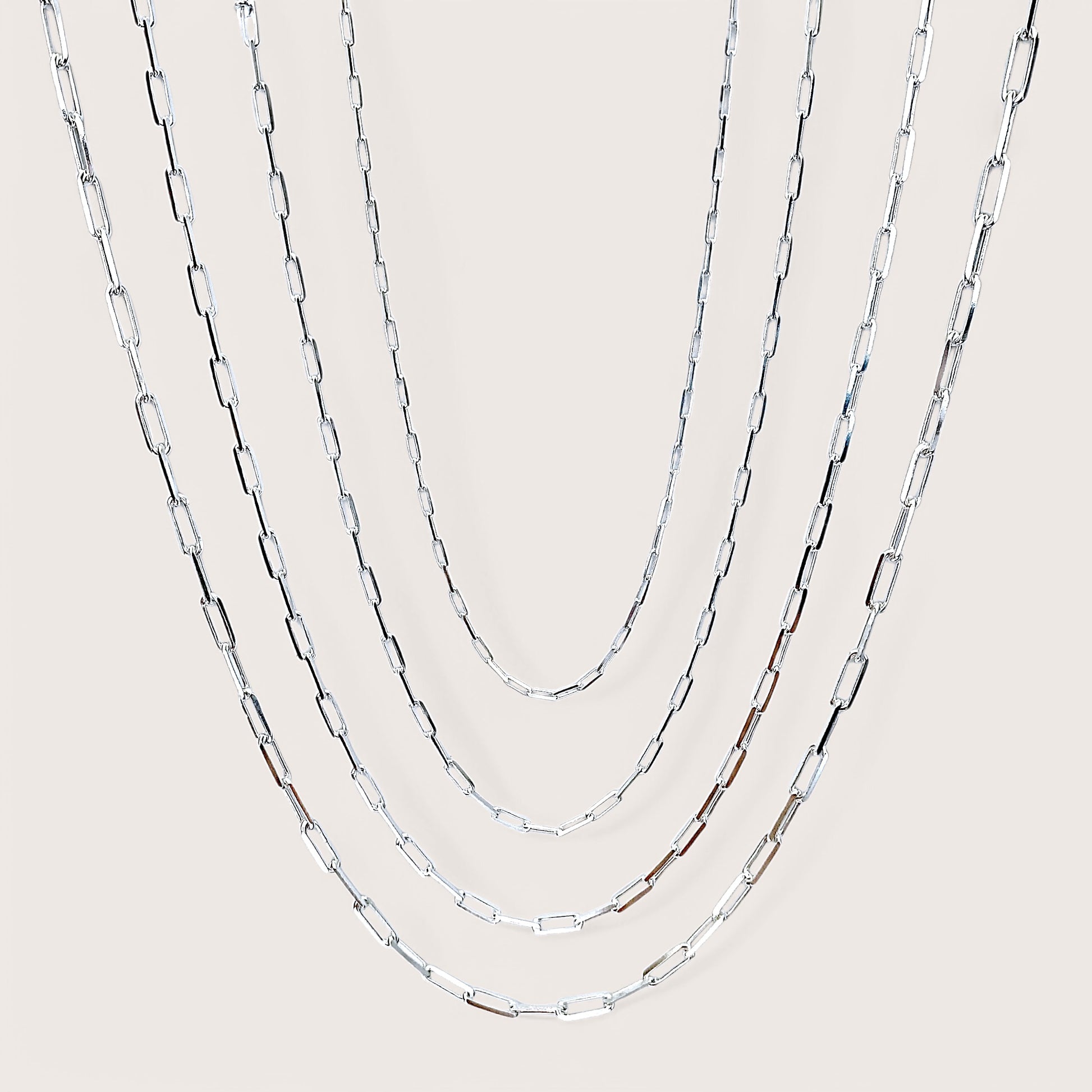 Side by Side of Solid 925 Italain Sterling Silver Paperclip Chain Necklaces for Men & Women. Chains are layered  showing virus width and length options. 