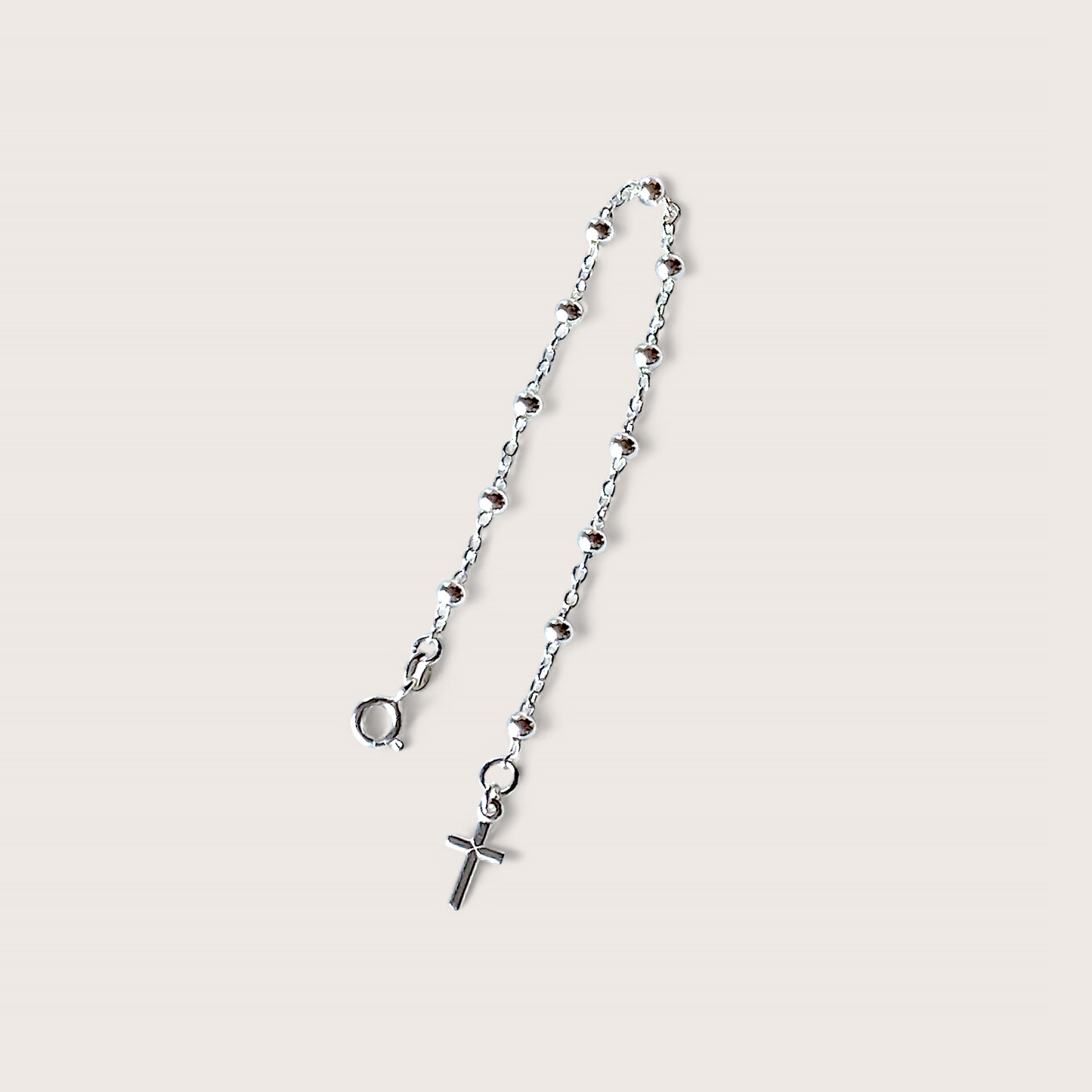 Close up of dainty silver  Rosemary Bead Chain Bracelet with a Cross