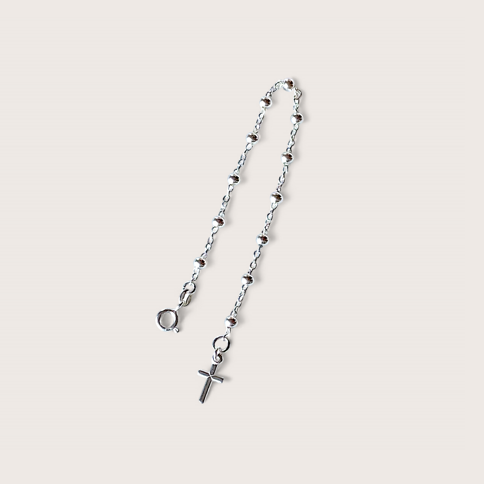 Close up of dainty silver  Rosemary Bead Chain Bracelet with a Cross